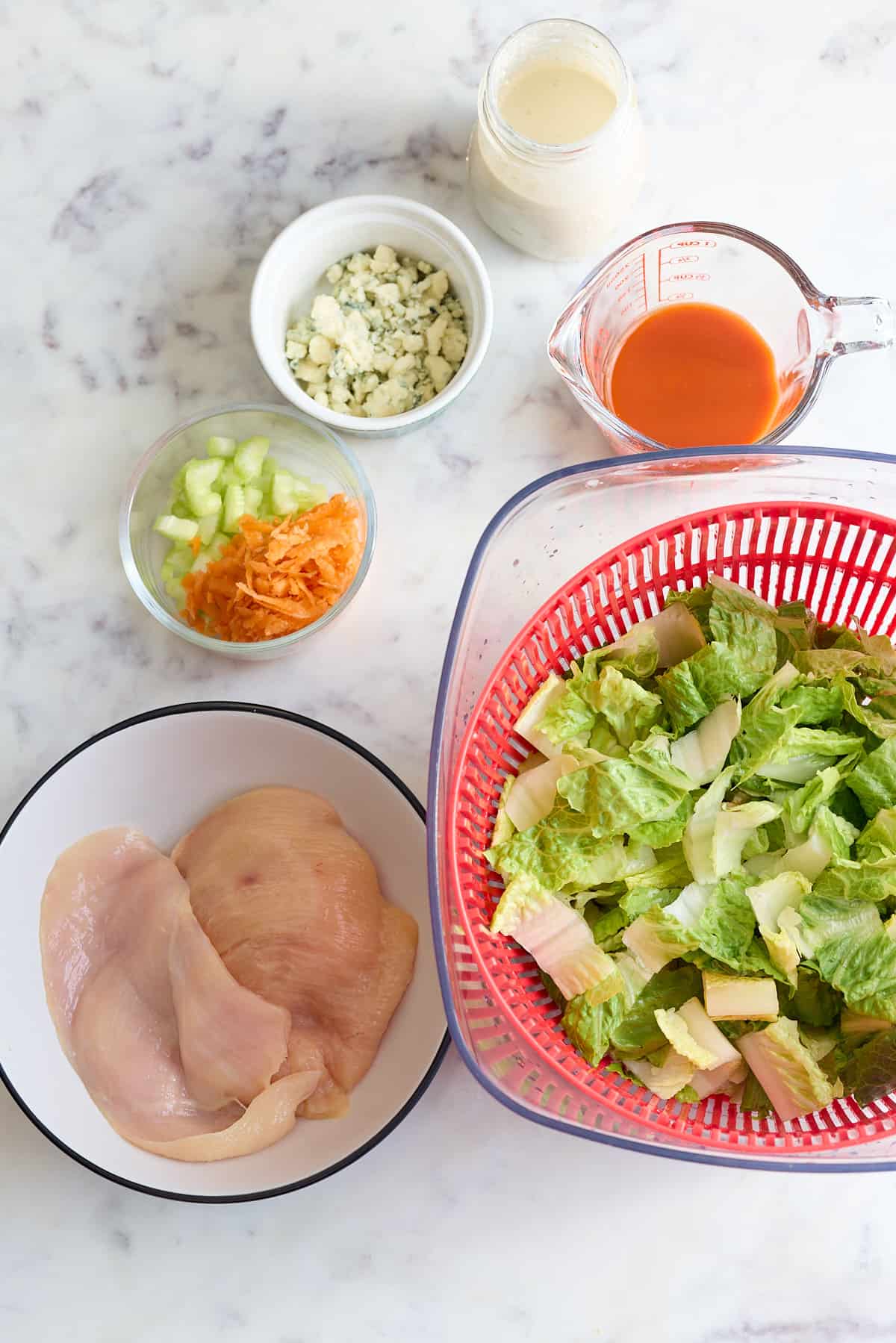ingredients for buffalo chicken salad on table